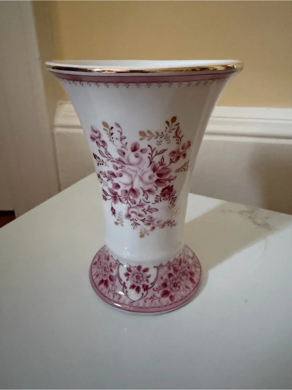 A vintage fluted vase w raspberry floral motif.